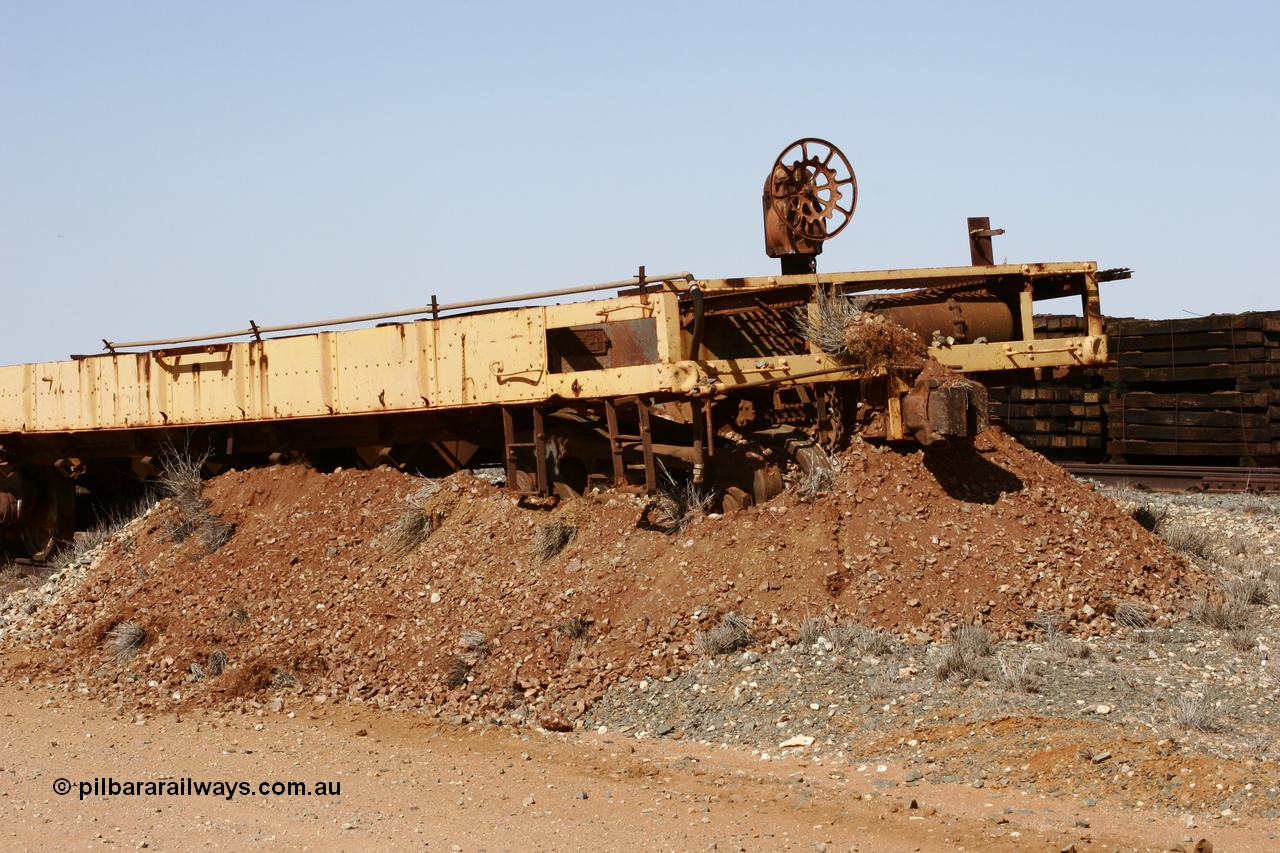 051001 5627
Flash Butt yard, heavily stripped down riveted waggon 206, possible original ballast waggon, number 206 was originally a waggon in the 'Camp Train' and appears to have USA origin, view of handbrake end, pushed into earth bund.
Keywords: BHP-flat-waggon;