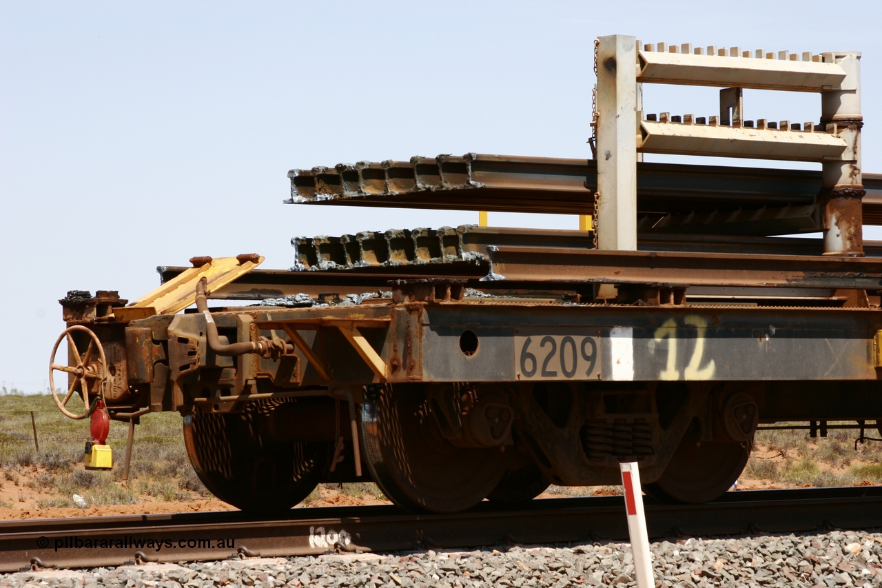 051001 5686
Boodarie, the Steel Train or rail recovery and transport train, hand brake end of waggon #12, 6209, a Comeng WA built flat waggon from January 1977 under order no. 07-M-282 RY.
Keywords: Comeng-WA;BHP-rail-train;