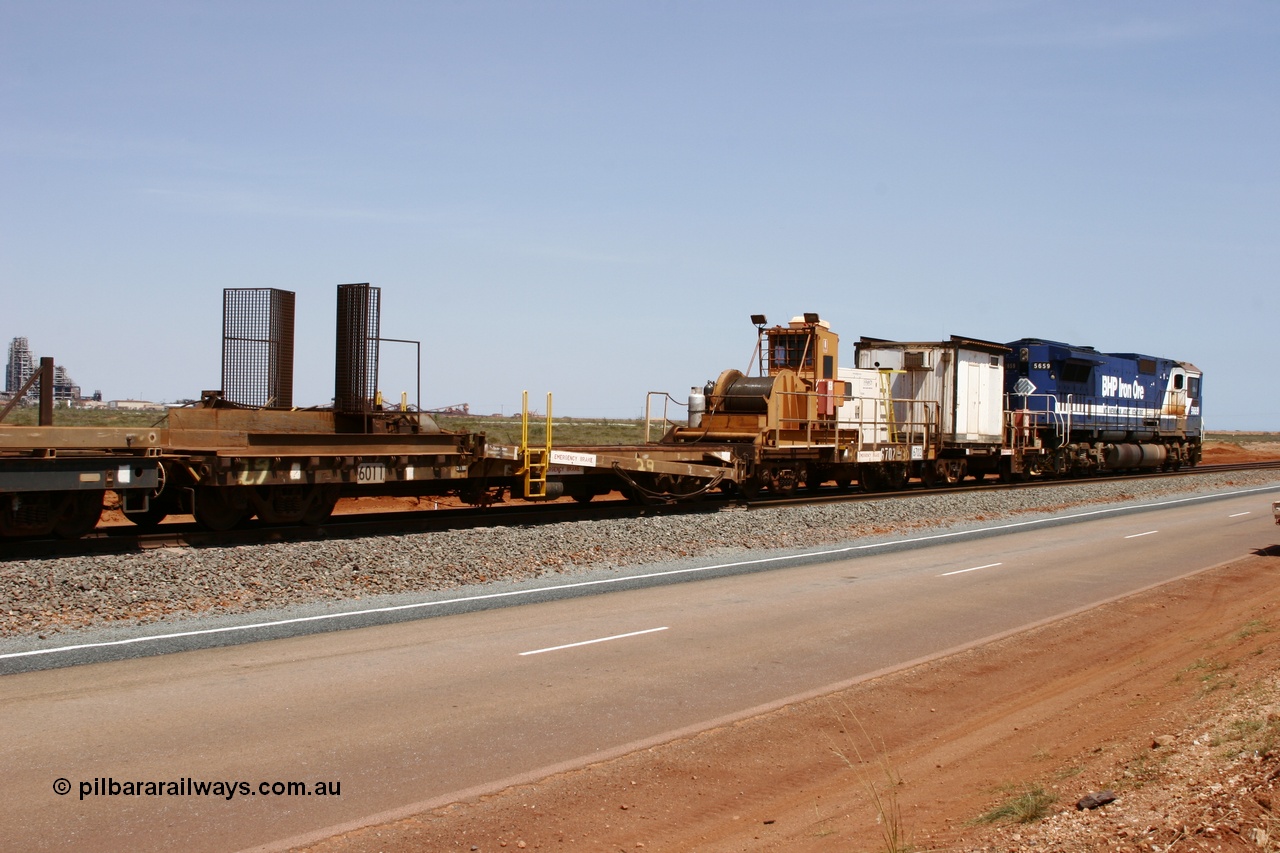051001 5725
Boodarie, the Steel Train or rail recovery and transport train, 1st lead off waggon 6011, built by Scotts of Ipswich 04-09-1970, the mesh guarding is for the winch cable. The chute arrangement for the discharging and recovery of rail is visible. Then 6702 winch waggon and 665 the crib waggon.
Keywords: Scotts-Qld;BHP-rail-train;