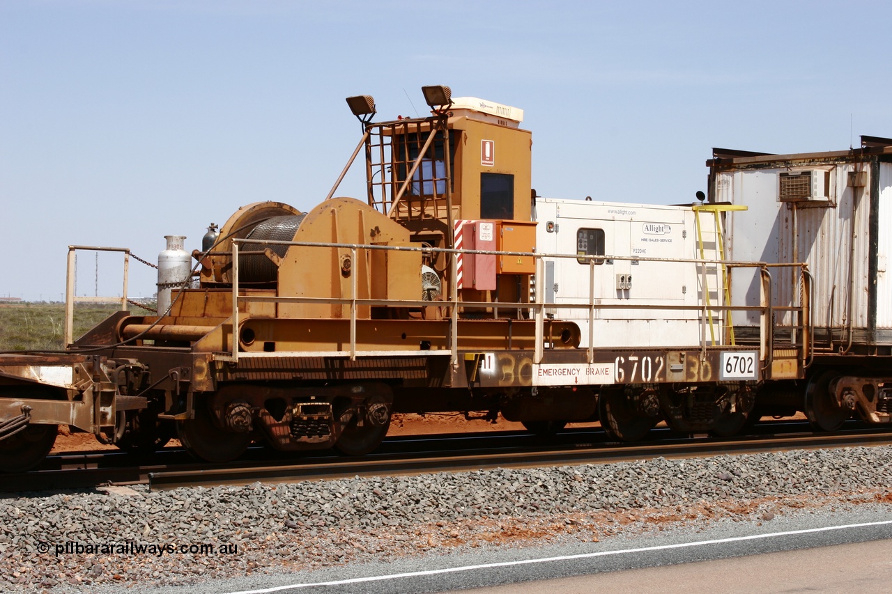 051001 5727
Boodarie, the Steel Train or rail recovery and transport train, flat waggon #30, 6702, heavily cut down and modified Magor USA ore waggon by Mt Newman Mining workshops, converted to a 50 tonne waggon and designated the winch waggon with generator set to power the winch and the crib car.
Keywords: Magor-USA;Mt-Newman-Mining-WS;BHP-rail-train;