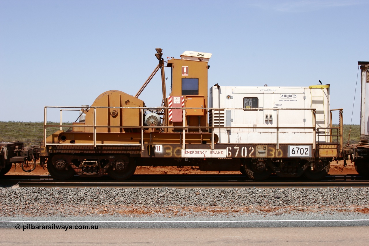 051001 5730
Boodarie, the Steel Train or rail recovery and transport train, flat waggon #30, 6702, heavily cut down and modified Magor USA ore waggon by Mt Newman Mining workshops, converted to a 50 tonne waggon and designated the winch waggon with generator set to power the winch and the crib car.
Keywords: Magor-USA;Mt-Newman-Mining-WS;BHP-rail-train;