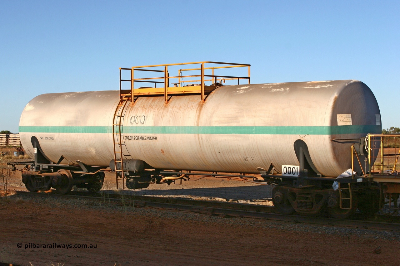 060429 3748
Flash Butt yard - South Hedland, water tank waggon 0001, originally built by Comeng NSW in November 1970 as one of two waggons with an 82,000 litre capacity. The other unit 0002 went on to become fuel tank 0020 after being converted to a weed spray waggon. 29th April 2006.
Keywords: Comeng-NSW;BHP-tank-waggon;