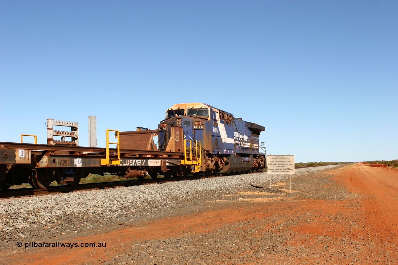060721 7335
Bing Siding, rail recovery and transport train flat waggon rear lead off waggon 6203, built by Comeng WA in January 1977. The AC6000 loco on the rear has a pulled coupler and is being towed to Hedland.
Keywords: Comeng-WA;BHP-rail-train;