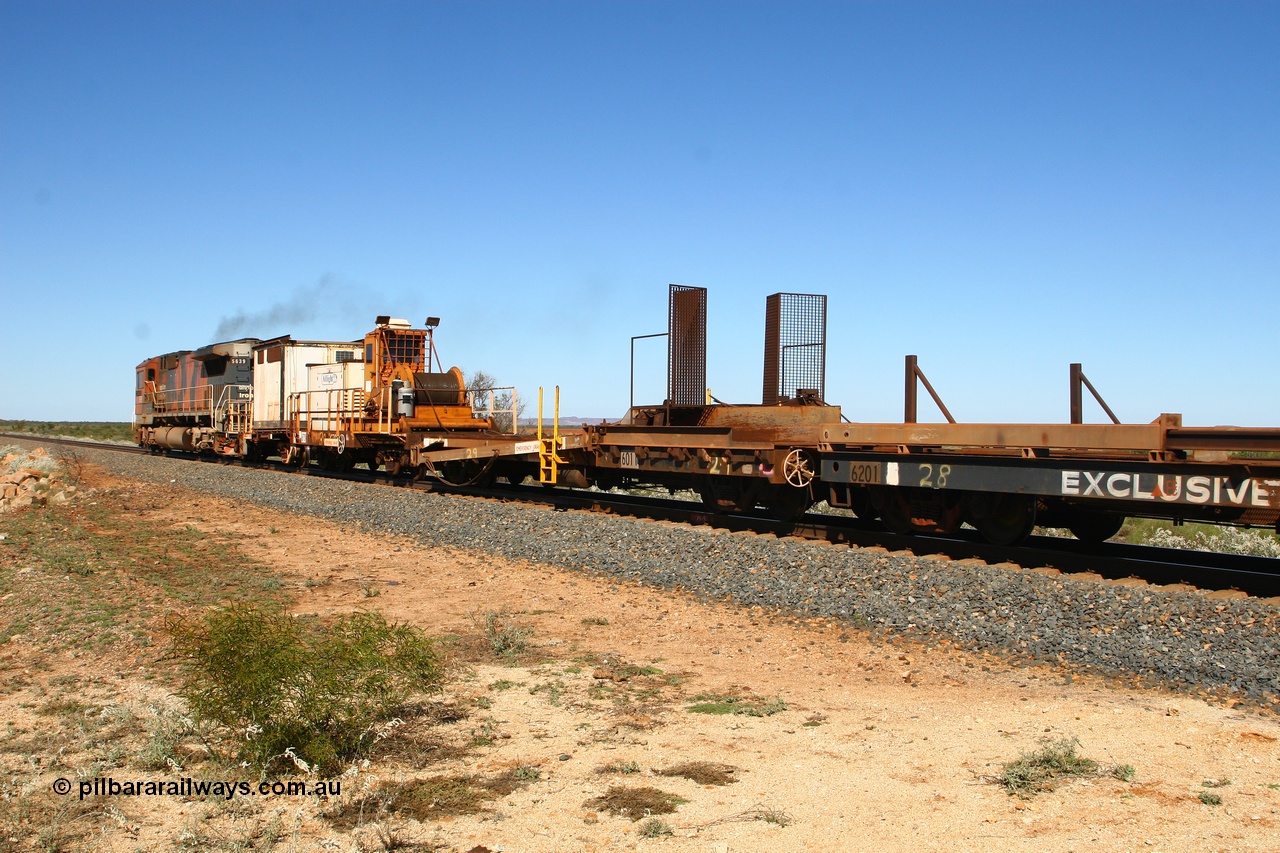 080621 2714
Tabba South, rail recovery and transport train, waggon #29, 1st lead off waggon 6011, built by Scotts of Ipswich Qld on 04-09-1970, the mesh guarding is for the winch cable. The chute arrangement for the discharging and recovery of rail is visible. In between 6702 and 6201.
Keywords: BHP-rail-train;Scotts-Qld;