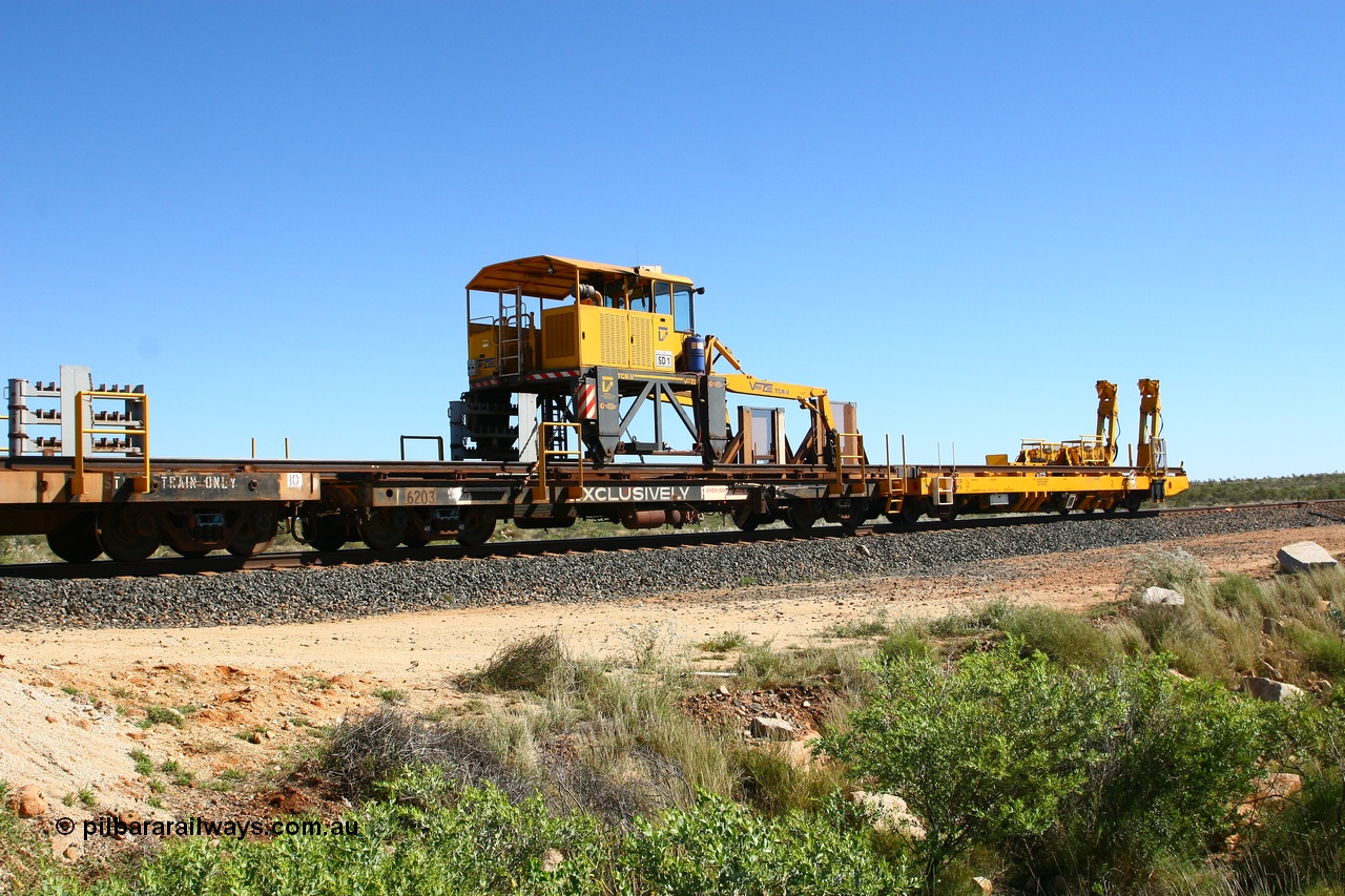080621 2721
Tabba South, rail recovery and transport train flat waggon #1, rear lead off waggon 6203, built by Comeng WA in January 1977. The straddle crane is a newish unit built by Vaia Car model no. TCR-V and the four wheels are chain driven, replacing the original Gemco hydraulic unit.
Keywords: Comeng-WA;BHP-rail-train;