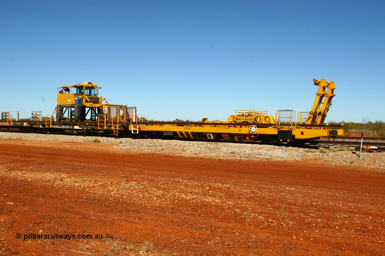 080621 2726
Gillman Siding, new Lead-Off Lead-On waggon STTR class STTR 6214 on the end of the Steel Train or rail recovery and transport train, built by Gemco Rail WA, the chutes can be seen standing up with the squeeze rollers behind the mesh with the original rear Lead-Off waggon 6203 and straddle crane.
Keywords: Gemco-Rail-WA;BHP-rail-train;STTR-type;STTR6214;