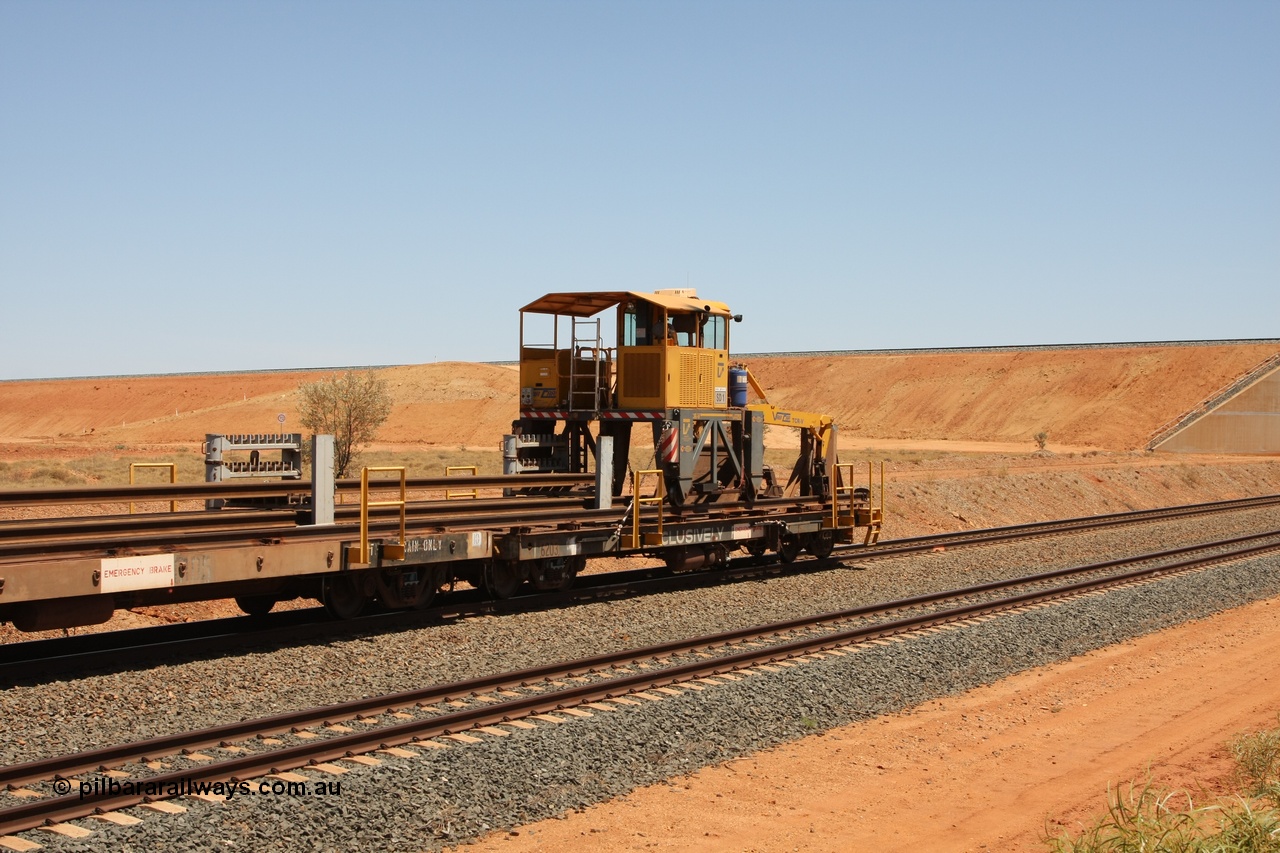 081217 0455
Woodstock Siding, rail recovery and transport train flat waggon #1, rear lead off waggon 6203, built by Comeng WA in January 1977 under order number 07-M-282 RY. The straddle crane is a newish unit built by Vaia Car model no. TCR-V and the four wheels are chain driven, replacing the original Gemco hydraulic unit.
Keywords: Comeng-WA;BHP-rail-train;