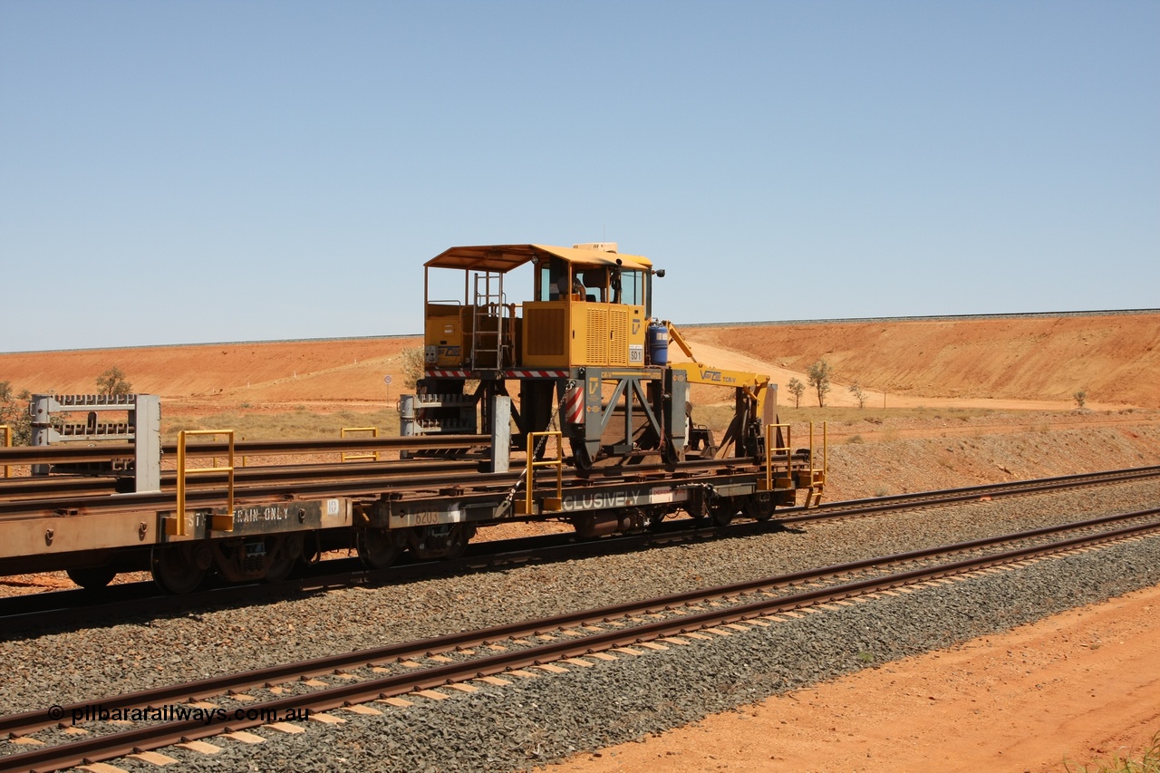 081217 0456
Woodstock Siding, rail recovery and transport train flat waggon #1, rear lead off waggon 6203, built by Comeng WA in January 1977 under order number 07-M-282 RY. The straddle crane is a newish unit built by Vaia Car model no. TCR-V and the four wheels are chain driven, replacing the original Gemco hydraulic unit.
Keywords: Comeng-WA;BHP-rail-train;