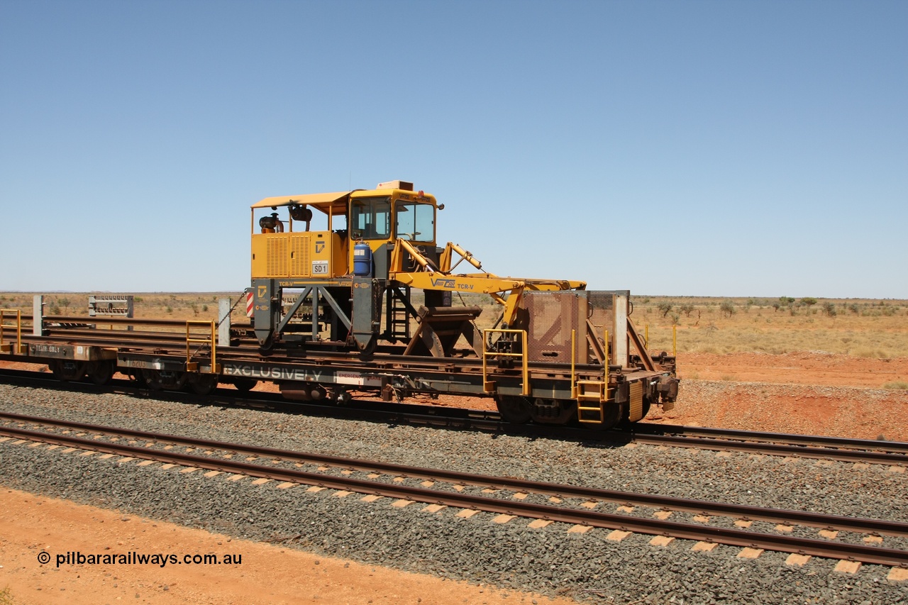 081217 0457
Woodstock Siding, rail recovery and transport train flat waggon #1, rear lead off waggon 6203, built by Comeng WA in January 1977 under order number 07-M-282 RY. The straddle crane is a newish unit built by Vaia Car model no. TCR-V and the four wheels are chain driven, replacing the original Gemco hydraulic unit.
Keywords: Comeng-WA;BHP-rail-train;