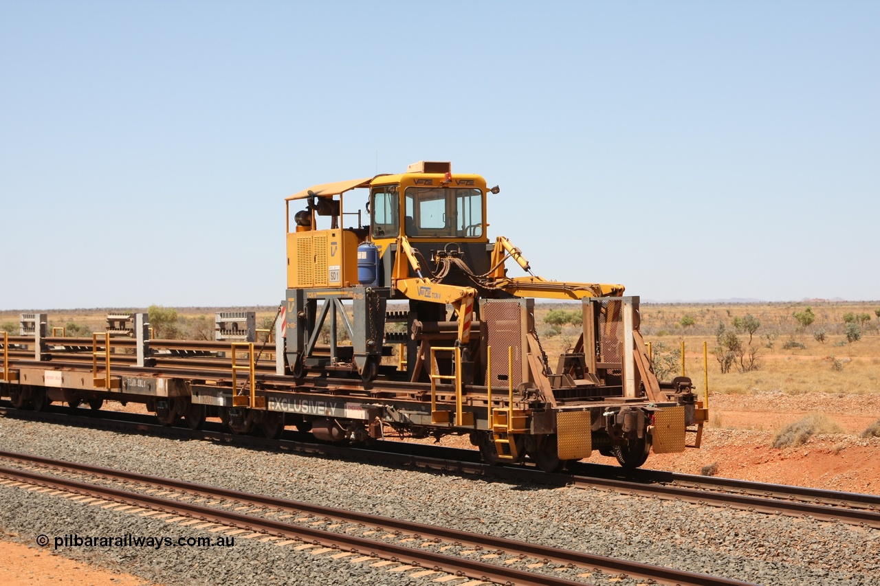 081217 0458
Woodstock Siding, rail recovery and transport train flat waggon #1, rear lead off waggon 6203, built by Comeng WA in January 1977 under order number 07-M-282 RY. The straddle crane is a newish unit built by Vaia Car model no. TCR-V and the four wheels are chain driven, replacing the original Gemco hydraulic unit.
Keywords: Comeng-WA;BHP-rail-train;