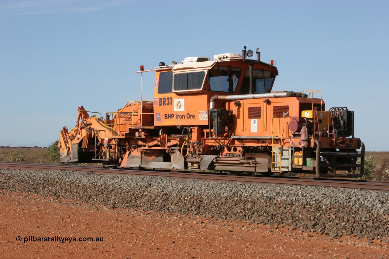 050411 0600
Goldsworthy Junction, BHP track machine ballast regulator BR 31 a Plasser Australia SSP 110SW model with serial 401 comes off the former Goldsworthy line with the Newman mainline in the foreground. 11th April 2005.
Keywords: BR31;Plasser-Australia;SSP-110SW;401;track-machine;