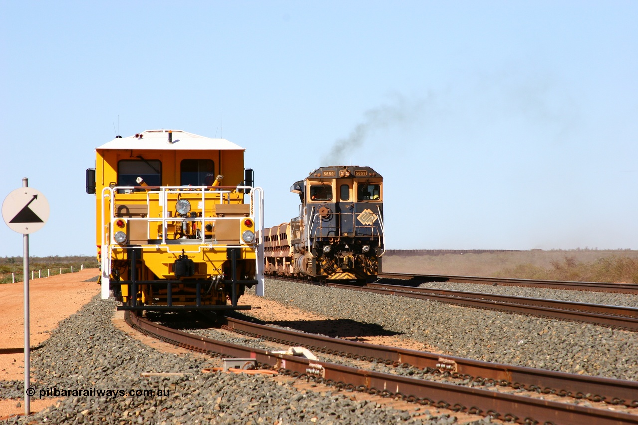 050625 3633
Mooka North backtrack holds BHP's new Tamper 3 track machine a Plasser Australia 09-3X model serial M480 as a ballast train runs past on the passing track as an empty ore train is on the mainline. 25th June 2005.
Keywords: Tamper3;Plasser-Australia;09-3X;M480;track-machine;
