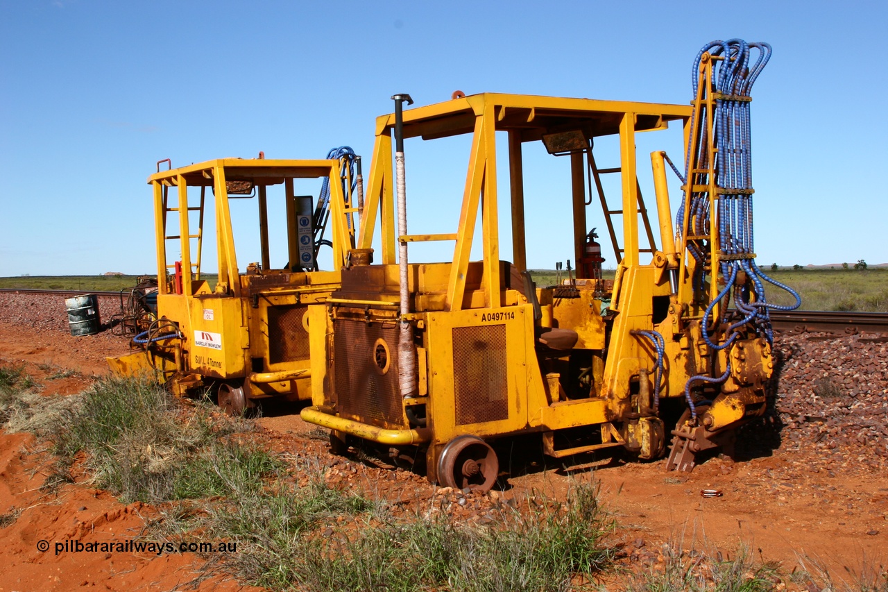 050625 3814
Node 2 at the 38 km on the GML or former Goldsworthy mainline, two Barclay Mowlem sleeper inserter track machines off clear of the running lines. 25th June 2005.
Keywords: track-machine;