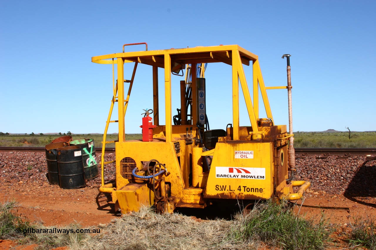 050625 3816
Node 2 at the 38 km on the GML or former Goldsworthy mainline, a Barclay Mowlem sleeper inserter track machine off clear of the running lines. 25th June 2005.
Keywords: track-machine;