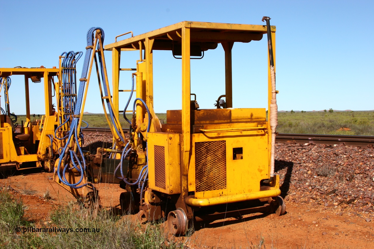 050625 3819
Node 2 at the 38 km on the GML or former Goldsworthy mainline, a Barclay Mowlem sleeper inserter track machine off clear of the running lines. 25th June 2005.
Keywords: track-machine;