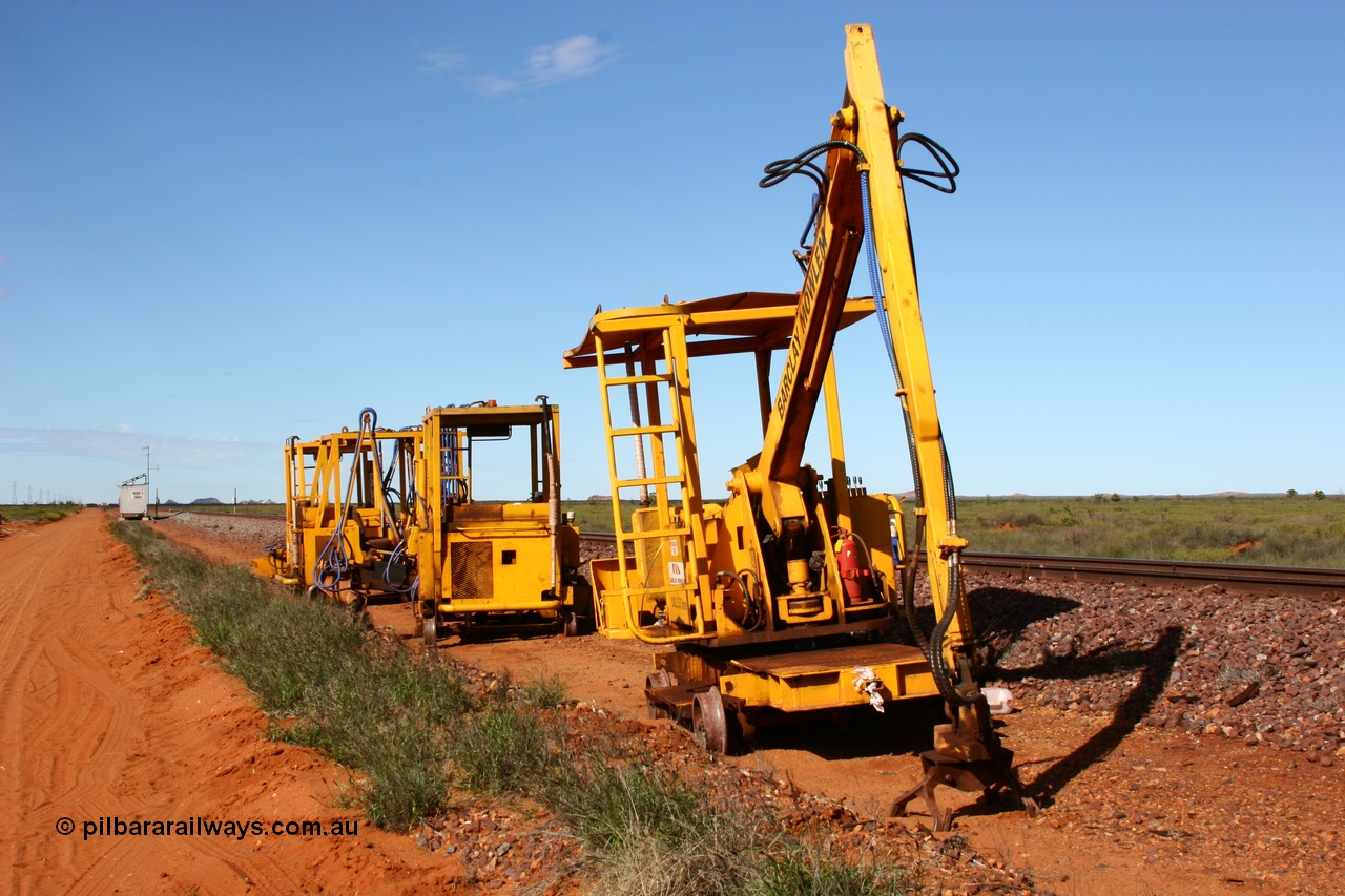 050625 3820
Node 2 at the 38 km on the GML or former Goldsworthy mainline, some Barclay Mowlem track machines are off clear of the running lines, a sleeper crane is at the front with three sleeper inserters behind. 25th June 2005.
Keywords: track-machine;