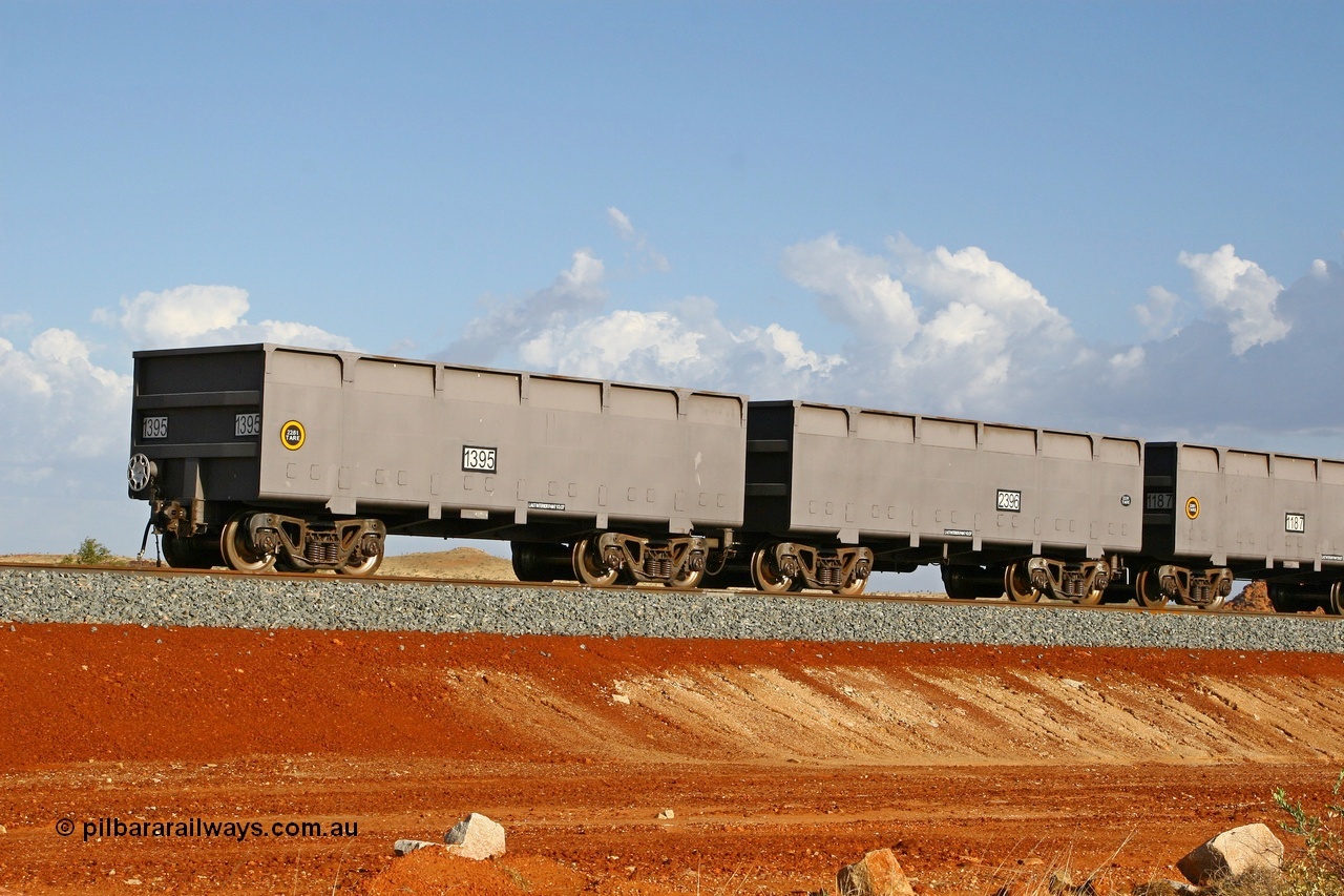080116 1364
Chapman Siding at the 69 km on FMG's under construction line to Cloud Break mine, new waggons stabled in the passing track awaiting service, built by China Southern or CSR at their Zhuzhou Rolling Stock Works in China in 2007, here slave waggon 1395 and master waggon 2396 sit in the arvo sunlight. The yellow circle indicates the rotary coupler end and the tare weight of the slave waggon at 22.6 tonnes, while the master weighs 22.9 tonnes as it hosts the brake control equipment. 16th January 2008. 
Keywords: 1395-2396;CSR-Zhuzhou-Rolling-Stock-Works-China;FMG-ore-waggon;