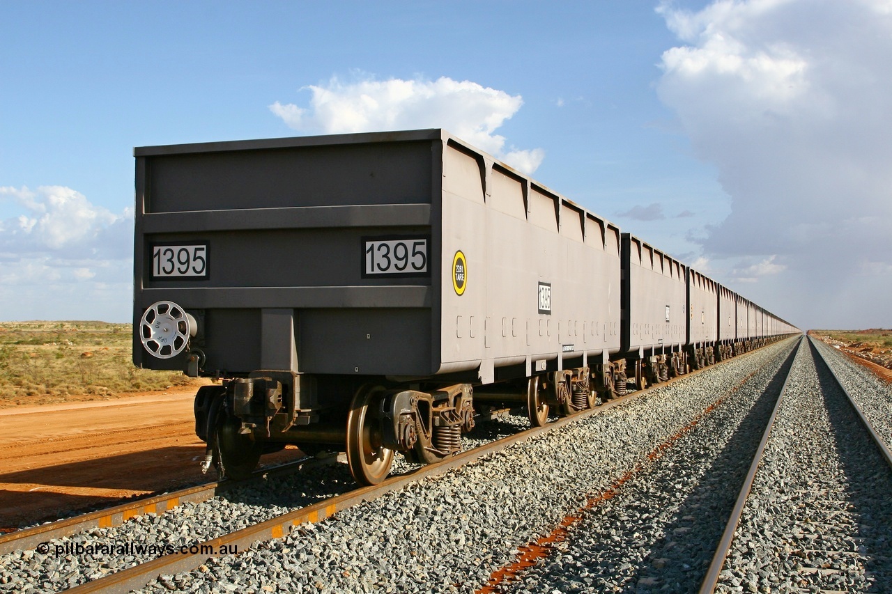 080116 1367
Chapman Siding at the 69 km on FMG's under construction line to Cloud Break mine, new waggons stabled in the passing track awaiting service, built by China Southern or CSR at their Zhuzhou Rolling Stock Works in China in 2007, looking south along the rake with 1395 closest to the camera. 16th January 2008.
Keywords: 1395;CSR-Zhuzhou-Rolling-Stock-Works-China;FMG-ore-waggon;