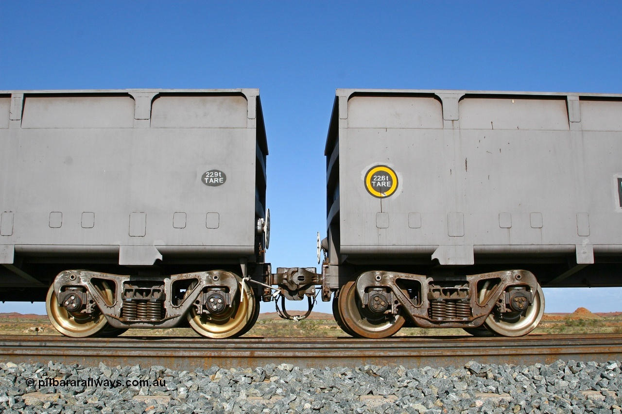 080116 1375
Chapman Siding, view of FMG's CSR Zhuzhou Rolling Stock Works built waggons showing the 'F' type Interlock fixed and rotary couplers between master waggon 2396 and slave waggon 1187. Note the difference in the tare weights, 2396 with the fixed coupler is the master waggon, while 1187 is the slave waggon with the rotary coupler. The yellow circle also denotes the rotary coupler end. 16th January 2008.
Keywords: 2396;CSR-Zhuzhou-Rolling-Stock-Works-China;FMG-ore-waggon;