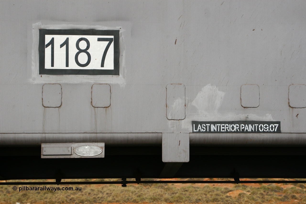 080116 1376
Chapman Siding, FMG slave waggon 1187, built by China Southern or CSR at their Zhuzhou Rolling Stock Works in China during 2007, view of the number decal builders plate and bracket for RFID tag with the last painted date placard. 16th January 2008.
Keywords: 1187;CSR-Zhuzhou-Rolling-Stock-Works-China;FMG-ore-waggon;