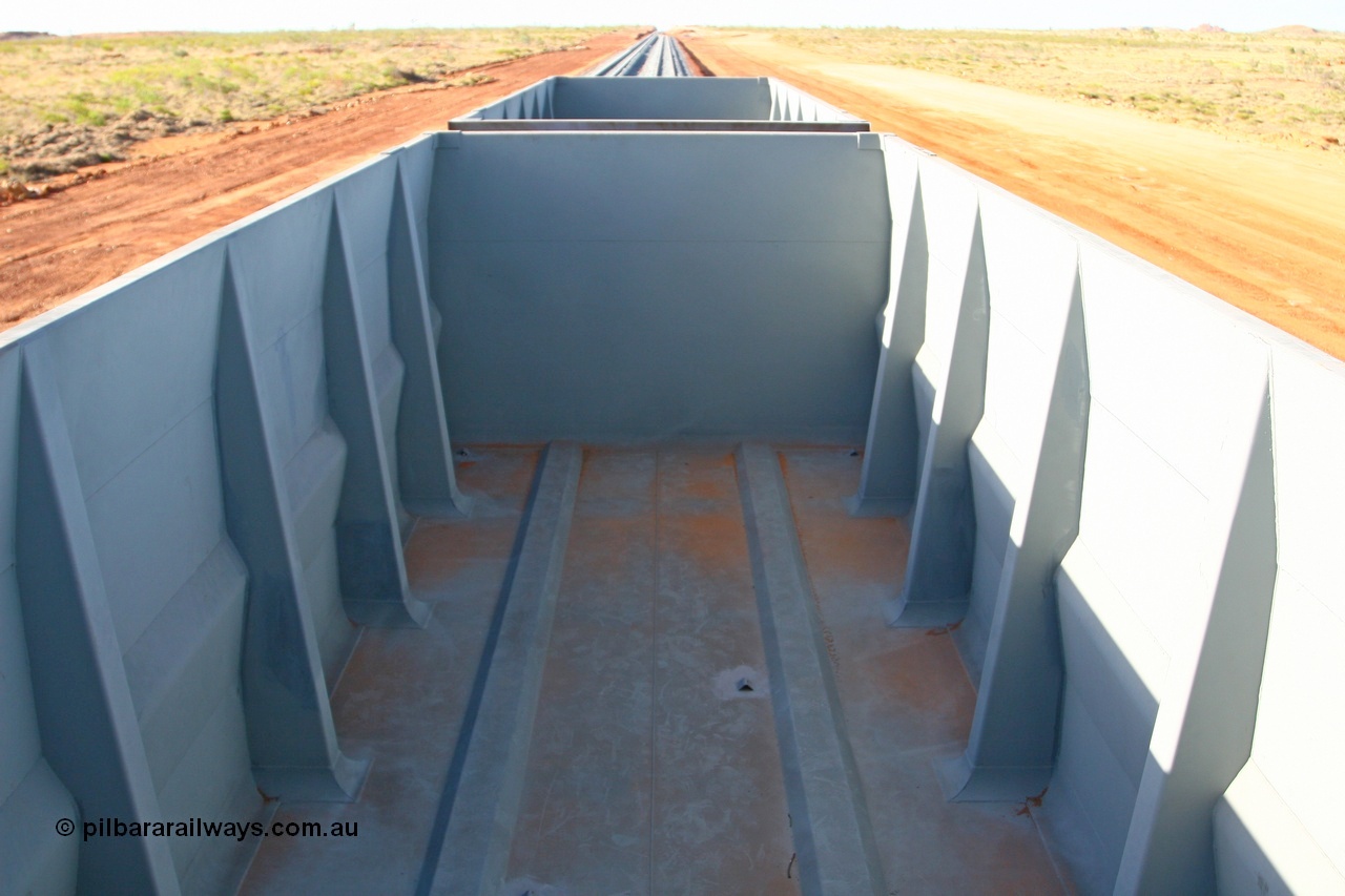 080116 1381
Chapman Siding looking north inside ore waggon 2396. The visible angle iron welded to the floor are covers for the water drain holes.
Keywords: 2396;CSR-Zhuzhou-Rolling-Stock-Works-China;FMG-ore-waggon;