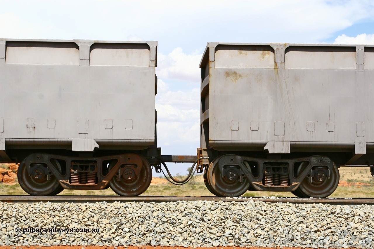 080124 1633
Chapman Siding, detail of the bar coupling arrangement showing bar, the large hose is the through brake pipe and the small hose the control pipe for the slave waggon. 24th January 2008.
Keywords: FMG-ore-waggon;