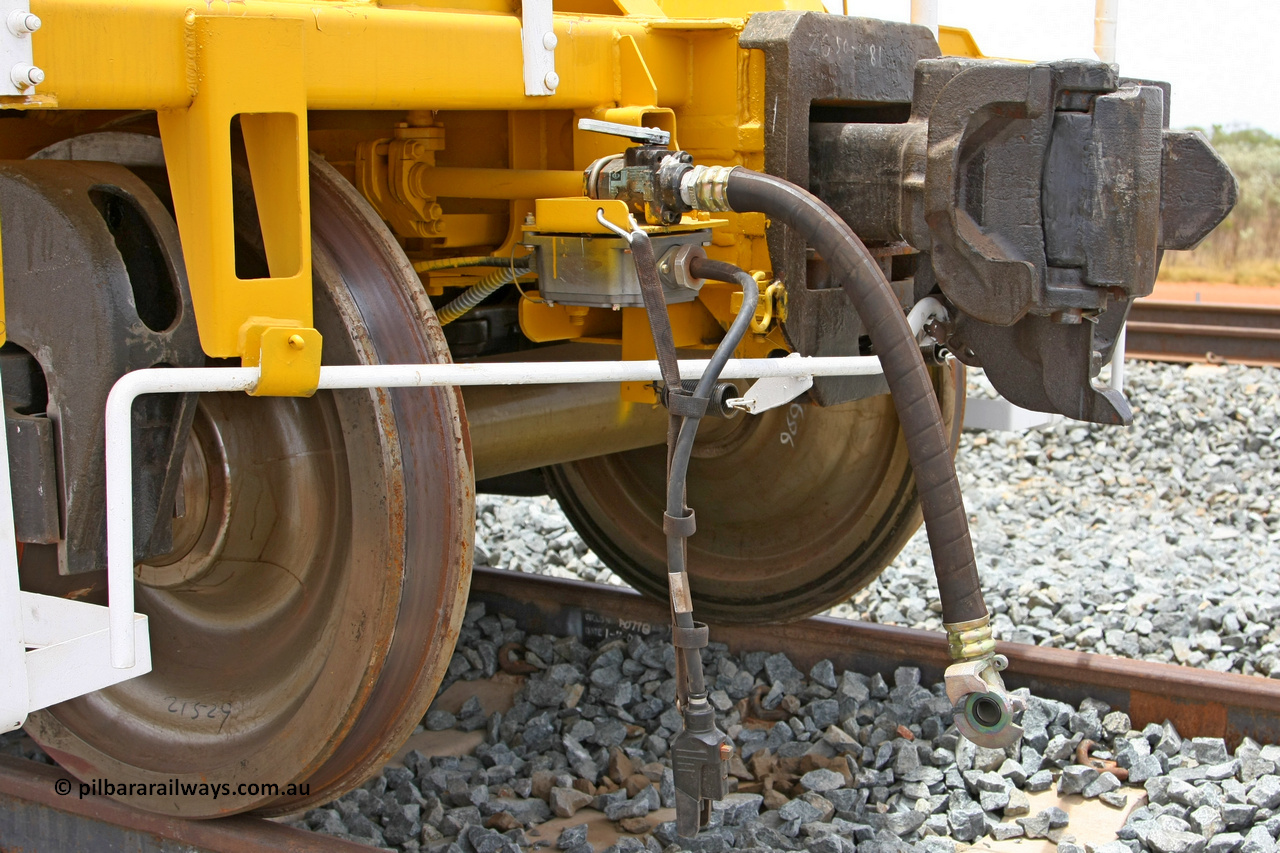 081225 0568
Barker Siding, one of FMG's thirty five ballast waggons, BH 11, view of F type coupler and air and electric connections, 100 tonne capacity, built in China by CSR at the Yangtze Rolling Stock Company in 2008. December 25, 2008.
Keywords: BH11;CSR-Yangtze-Rolling-Stock-Co-China;FMG-ballast-waggon;