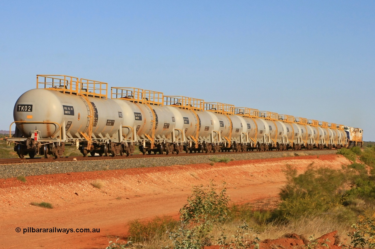 110620 2284
Chapman, the entire fleet of twelve FMG TK type fuel tank waggons all built in 2008 by CSR Zhuzhou Rolling Stock Works plant in China hurry south on the loaded run of the fuel train to Cloud Break mine. 20th June 2011.
Keywords: TK02;TK-type;CSR-Zhuzhou-Rolling-Stock-Works-China;FMG-tank-waggon