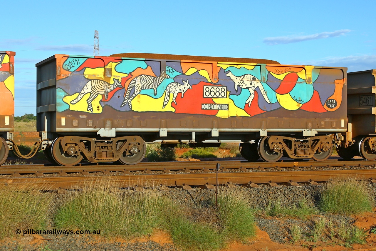 200412 6178
Boodarie, part of a loaded FMG train, painted ore waggon pair 7687 - 8688 built by CRRC Yangtze Rolling Stock Co. of China in 2018, 8688 waggon view, it features mural painting by students of South Hedland High School and was painted in August 2018. April 12, 2020.
Keywords: 7687-8688;CRRC-Yangtze-China;FMG-ore-waggon