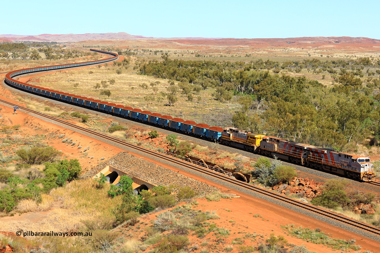 240701 2381
Western Creek, 67 km, Rio Tinto's GE built ES44DCi locomotive 9141 with serial number 64731, delivered in 2018 from the sixth order of this model from GE leads an ES44DCi and 9-44CW locomotives as they snake around the curve between Western Creek and Green Pool with a loaded train of the second rake of blue waggons bound for Cape Lambert. Captured on July 1, 2024.
Keywords: 9141;GE;ES44ACi;64731;