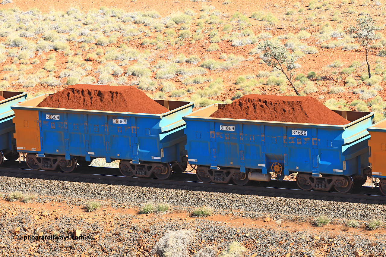 240701 2392
Western Creek, 67 km, one of Rio Tinto's blue rakes with spring assisted park brake and only electronic controlled pneumatic [ECP] braking, waggon pair 31669 is a master and is bar coupled to slave waggon 36669 built by China Northen as a Q type in 11/2022. Captured on July 1, 2024.
Keywords: 31669;36669;Q-type;China-Northern;Rio-ore-waggon;