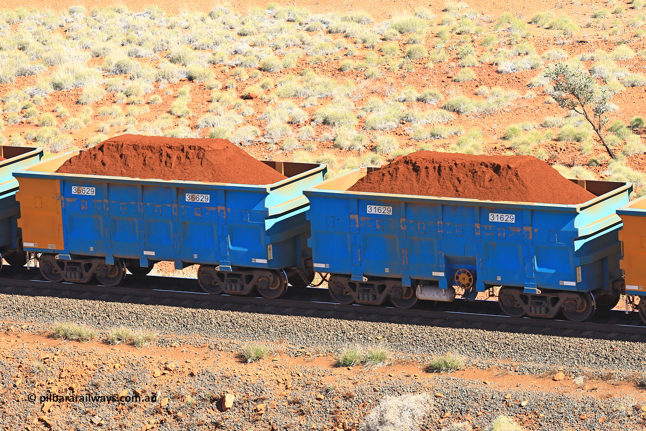 240701 2421
Western Creek, 67 km, one of Rio Tinto's blue rakes with spring assisted park brake and only electronic controlled pneumatic [ECP] braking, waggon pair 31629 is a master and is bar coupled to slave waggon 36629 built by China Northen as a Q type in 11/2022. Captured on July 1, 2024.
Keywords: 31629;36629;Q-type;China-Northern;Rio-ore-waggon;