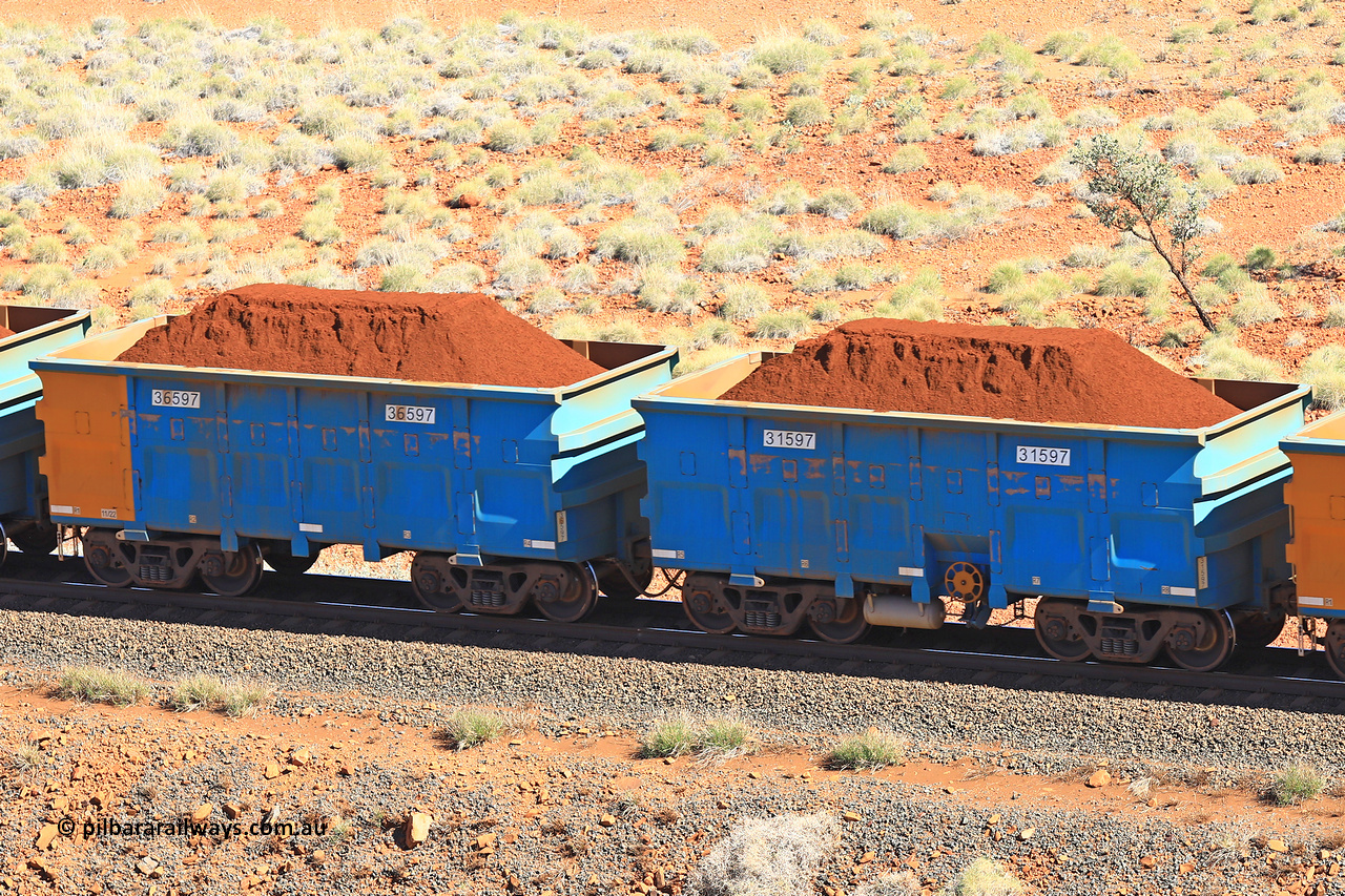 240701 2423
Western Creek, 67 km, one of Rio Tinto's blue rakes with spring assisted park brake and only electronic controlled pneumatic [ECP] braking, waggon pair 31597 is a master and is bar coupled to slave waggon 36597 built by China Northen as a Q type in 11/2022. Captured on July 1, 2024.
Keywords: 31597;36597;Q-type;China-Northern;Rio-ore-waggon;