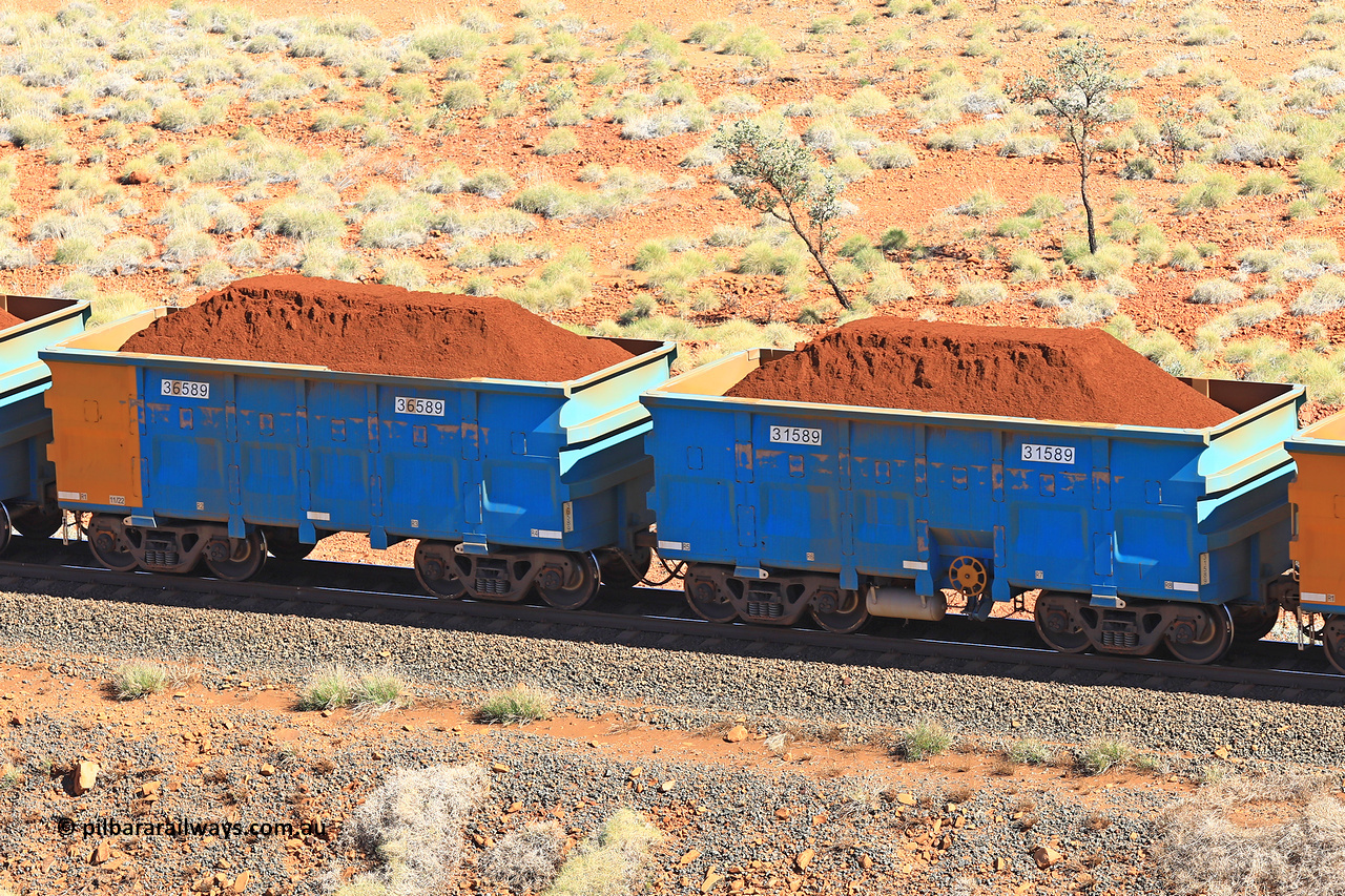 240701 2435
Western Creek, 67 km, one of Rio Tinto's blue rakes with spring assisted park brake and only electronic controlled pneumatic [ECP] braking, waggon pair 31589 is a master and is bar coupled to slave waggon 36589 built by China Northen as a Q type in 11/2022. Captured on July 1, 2024.
Keywords: 31589;36589;Q-type;China-Northern;Rio-ore-waggon;