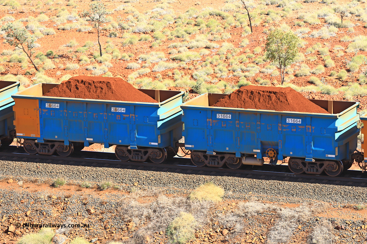 240701 2457
Western Creek, 67 km, one of Rio Tinto's blue rakes with spring assisted park brake and only electronic controlled pneumatic [ECP] braking, waggon pair 31664 is a master and is bar coupled to slave waggon 36664 built by China Northen as a Q type in 11/2022. Captured on July 1, 2024.
Keywords: 31664;36664;Q-type;China-Northern;Rio-ore-waggon;