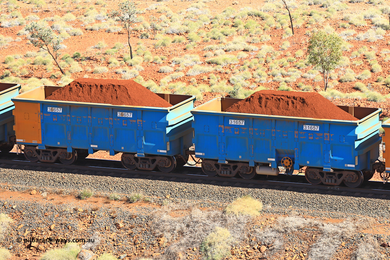 240701 2462
Western Creek, 67 km, one of Rio Tinto's blue rakes with spring assisted park brake and only electronic controlled pneumatic [ECP] braking, waggon pair 31657 is a master and is bar coupled to slave waggon 36657 built by China Northen as a Q type in 11/2022. Captured on July 1, 2024.
Keywords: 31657;36657;Q-type;China-Northern;Rio-ore-waggon;
