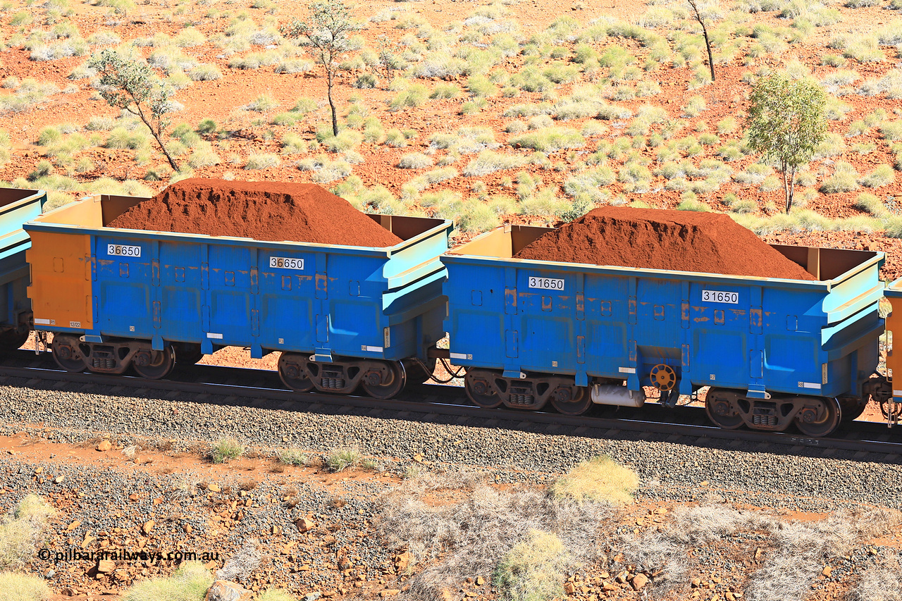 240701 2469
Western Creek, 67 km, one of Rio Tinto's blue rakes with spring assisted park brake and only electronic controlled pneumatic [ECP] braking, waggon pair 31650 is a master and is bar coupled to slave waggon 36650 built by China Northen as a Q type in 12/2022. Captured on July 1, 2024.
Keywords: 31650;36650;Q-type;China-Northern;Rio-ore-waggon;