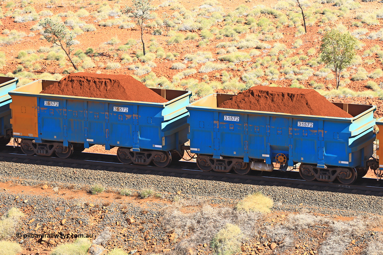 240701 2477
Western Creek, 67 km, one of Rio Tinto's blue rakes with spring assisted park brake and only electronic controlled pneumatic [ECP] braking, waggon pair 31572 is a master and is bar coupled to slave waggon 36572 built by China Northen as a Q type in 12/2022. Captured on July 1, 2024.
Keywords: 31572;36572;Q-type;China-Northern;Rio-ore-waggon;