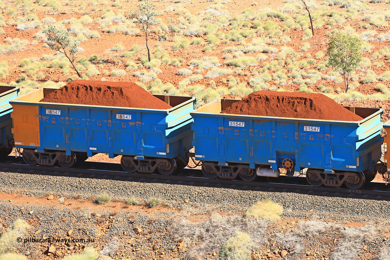 240701 2483
Western Creek, 67 km, one of Rio Tinto's blue rakes with spring assisted park brake and only electronic controlled pneumatic [ECP] braking, waggon pair 31547 is a master and is bar coupled to slave waggon 36547 built by China Northen as a Q type in 12/2022. Captured on July 1, 2024.
Keywords: 31547;36547;Q-type;China-Northern;Rio-ore-waggon;
