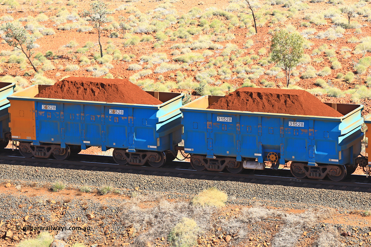 240701 2490
Western Creek, 67 km, one of Rio Tinto's blue rakes with spring assisted park brake and only electronic controlled pneumatic [ECP] braking, waggon pair 31528 is a master and is bar coupled to slave waggon 36528 built by China Northen as a Q type in 12/2022. Captured on July 1, 2024.
Keywords: 31528;36528;Q-type;China-Northern;Rio-ore-waggon;