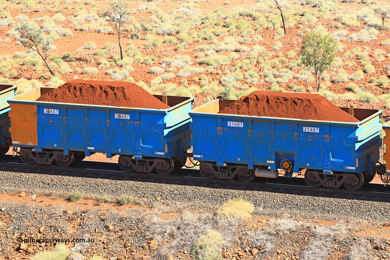 240701 2496
Western Creek, 67 km, one of Rio Tinto's blue rakes with spring assisted park brake and only electronic controlled pneumatic [ECP] braking, waggon pair 31487 is a master and is bar coupled to slave waggon 36487 built by China Northen as a Q type in 12/2022. Captured on July 1, 2024.
Keywords: 31487;36487;Q-type;China-Northern;Rio-ore-waggon;