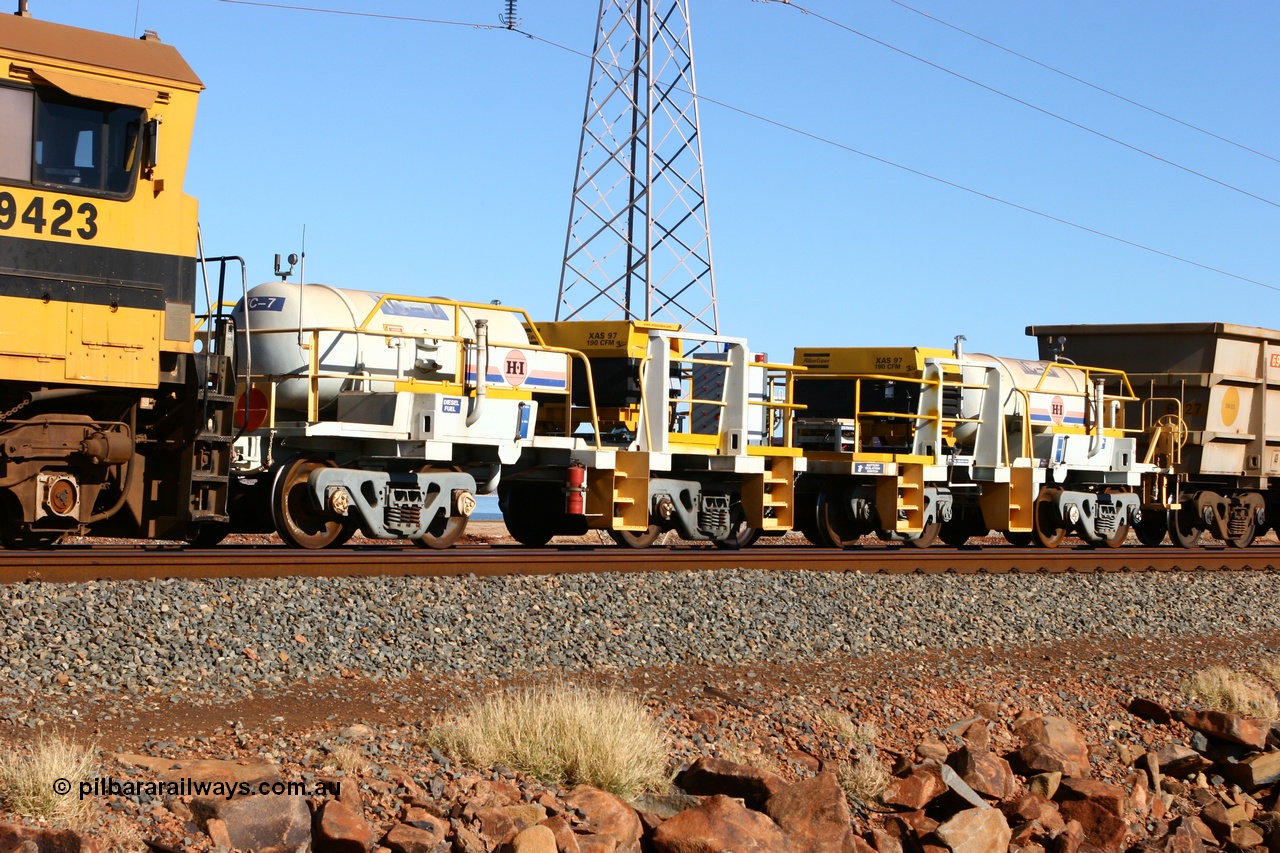 060723 7684
Original Hamersley Iron compressor waggon sets IC-6 and IC-7 which were made from cutting down condemned ore waggons and then fitting Atlas Copco XAS 97 air compressors, receiver tanks and fuel tanks. Seen here on the causeway just outside 7 Mile. 23rd July 2006.
Keywords: IC-6;IC-7;rio-compressor-waggon;