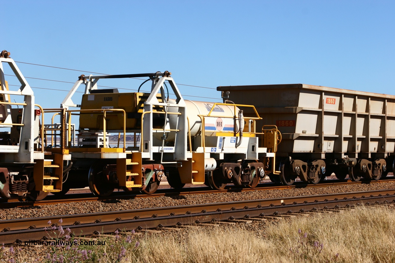 060724 7865
Original Hamersley Iron compressor waggon set IC-1 which were made from cutting down condemned ore waggons and then fitting Atlas Copco XAS 97 air compressors, receiver tanks and fuel tanks. The compressors have been fitted to a swing cradle to limit the in-train forces during the unloading process. 7 Mile 24th July 2006.
Keywords: IC-1;rio-compressor-waggon;