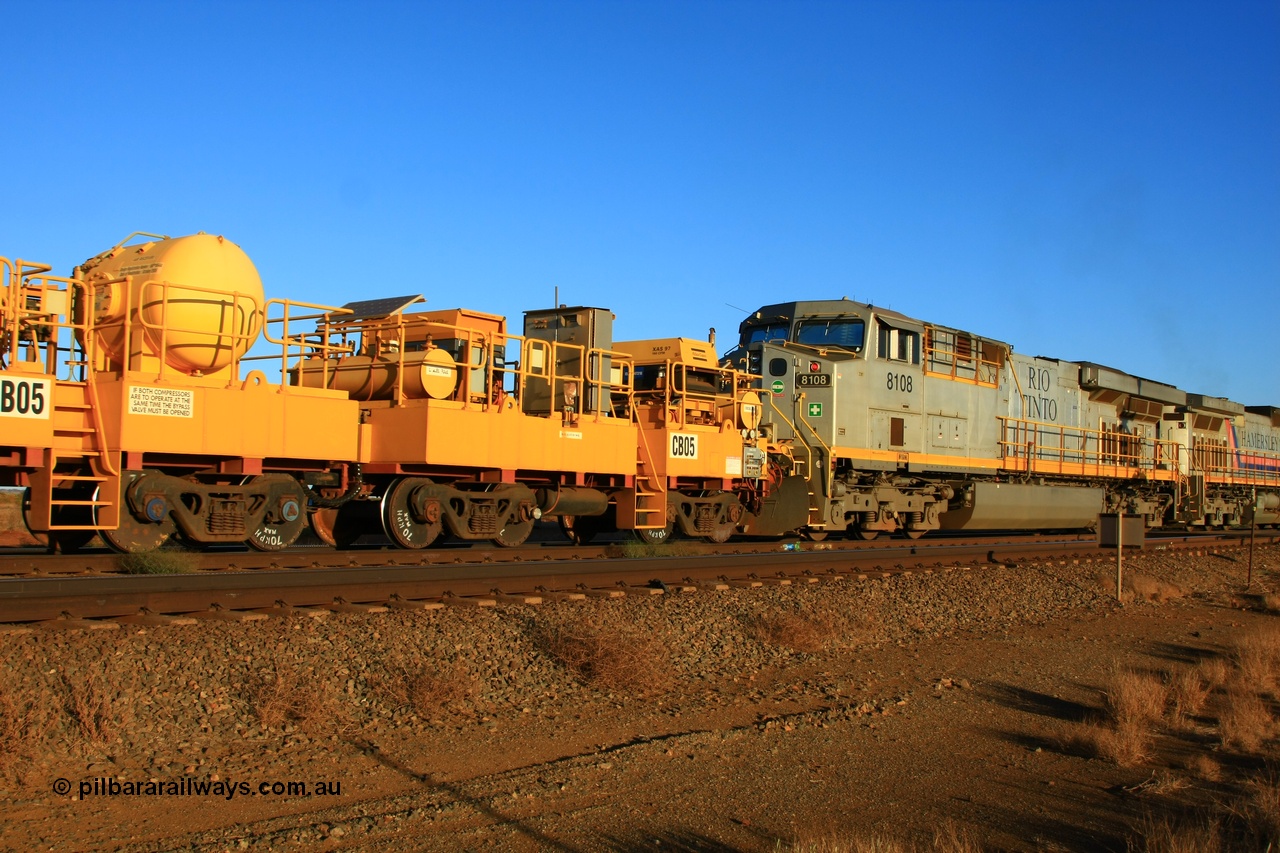 100329 8039
Rio Tinto compressor waggon set CB 05, compressor control waggon with two diesel powered Atlas Copco XAS 97's behind the loco and the receiver waggon with two air tanks or receivers closet to camera. Note the waggons are cut down ore waggons and the wheels are marked 70 kph max. Seen here just outside of 7 Mile. 29th March 2010.
Keywords: CB05;rio-compressor-waggon;