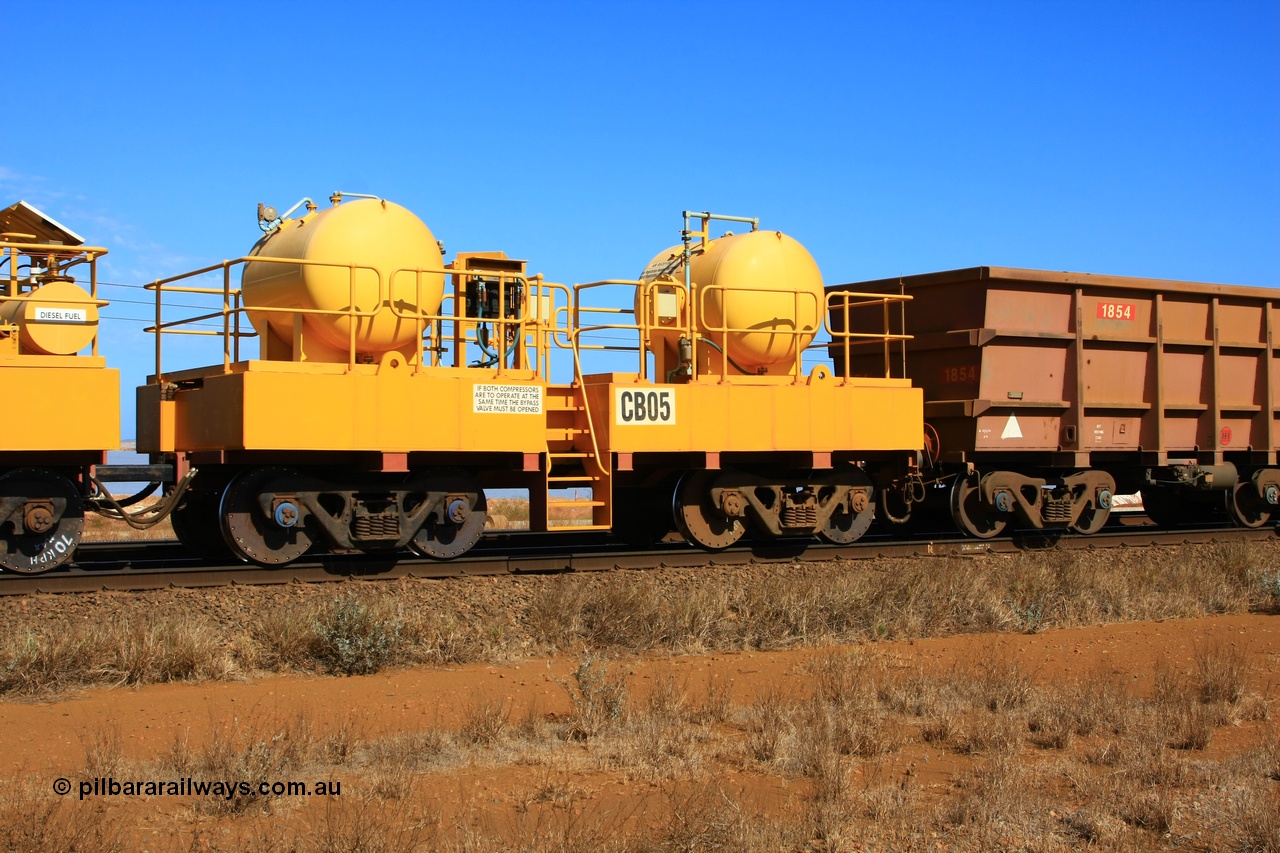 100330 8067
Rio Tinto compressor waggon set CB 05, receiver waggon with two air tanks or receivers. Note the waggons are cut down ore waggons and the wheels are marked 70 kph max. Seen here just outside of 7 Mile. 30th March 2010.
Keywords: CB05;rio-compressor-waggon;
