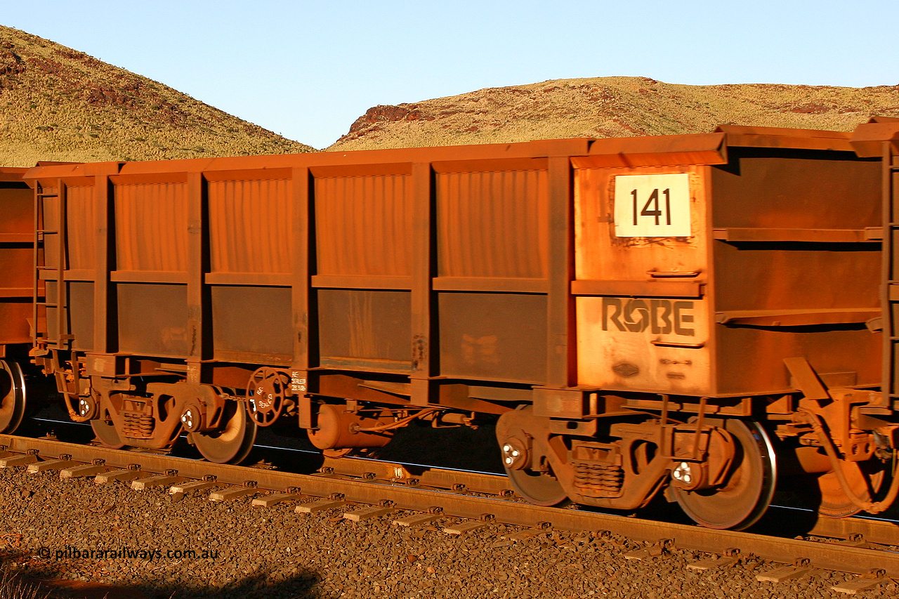0141 060722 7617
Robe River ore waggon 141, built by Nippon Sharyo Nihon, rotary coupler end handbrake side empty view, at the 11.7 km, Cape Lambert. July 22, 2006.
Keywords: 141;Nippon-Sharyo-Nihon;Robe-ore-waggon;