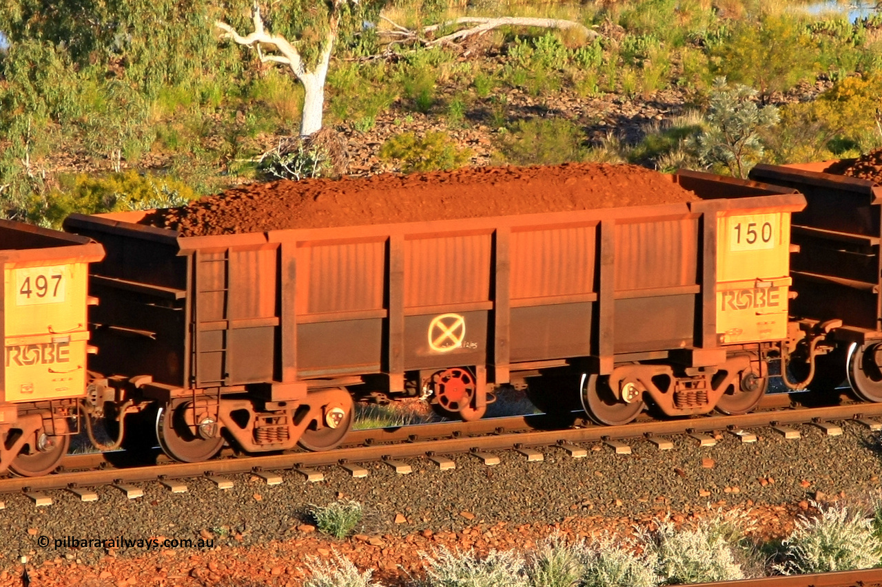 0150 110602 1597
Robe River ore waggon 150, built by Nippon Sharyo Nihon, fixed coupler handbrake side loaded view at the 71 km, Western Creek on the Deepdale line. June 2, 2011.
Keywords: 150;Nippon-Sharyo-Nihon;Robe-ore-waggon;