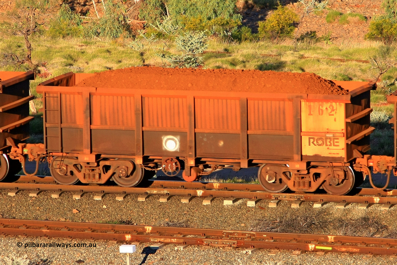 0162 110602 1675
Robe River ore waggon 162, built by Nippon Sharyo Nihon, rotary coupler end handbrake side loaded view at the 71 km, Western Creek on the Deepdale line. June 2, 2011.
Keywords: 162;Nippon-Sharyo-Nihon;Robe-ore-waggon;