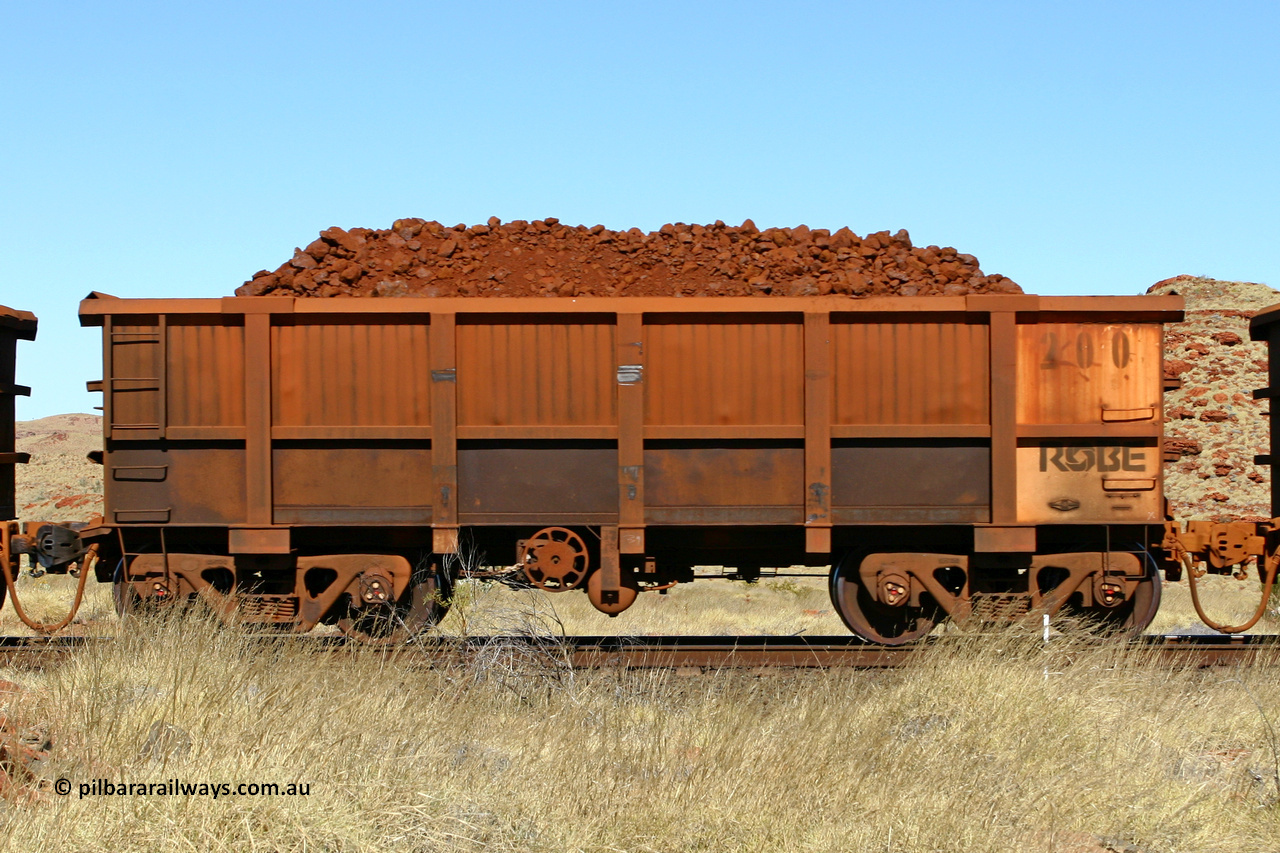0200 060722 7525
Robe River ore waggon 200, built by Nippon Sharyo Nihon, handbrake side loaded view at the 78.8 km between Western Creek and Maitland on the Deepdale line. July 22, 2006.
Keywords: 200;Nippon-Sharyo-Nihon;Robe-ore-waggon;