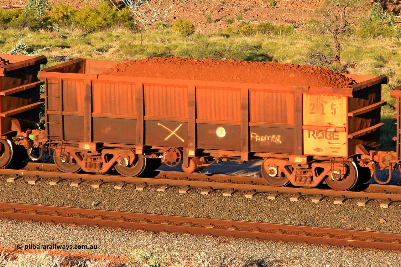 0215 110602 1733
Robe River ore waggon 215, built by Nippon Sharyo Nihon, rotary coupler end handbrake side loaded view at the 71 km, Western Creek on the Deepdale line. June 2, 2011.
Keywords: 215;Nippon-Sharyo-Nihon;Robe-ore-waggon;